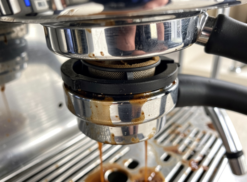 Backflushing a chrome espresso machine group head with a blind filter basket