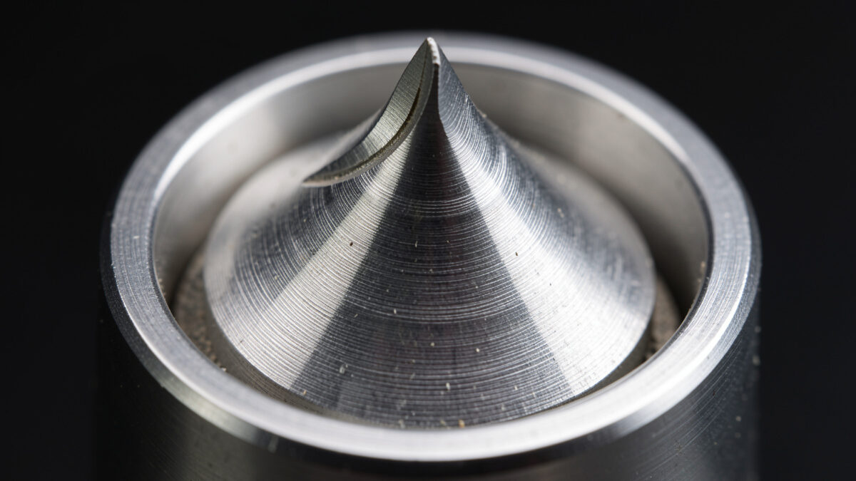 Flat burrs and conical burrs side by side showing the grinding surface geometry that shapes espresso flavour