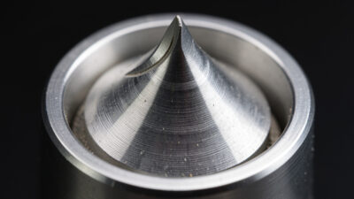 Flat burrs and conical burrs side by side showing the grinding surface geometry that shapes espresso flavour