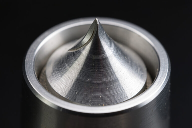 Flat burrs and conical burrs side by side showing the grinding surface geometry that shapes espresso flavour