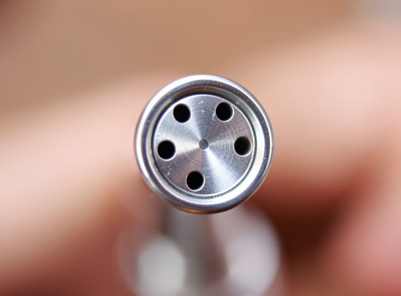 Close-up of a clean espresso steam wand tip showing the small steam holes